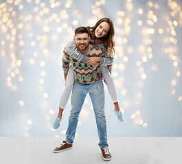 Image showing happy couple at christmas ugly sweater party