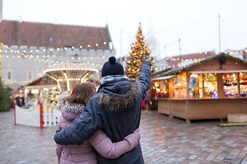 Image showing happy senior couple hugging at christmas market