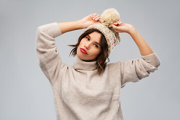 Image showing young woman in knitted winter hat and sweater