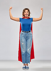 Image showing happy woman in red superhero cape showing power
