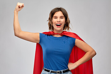 Image showing happy woman in red superhero cape showing power