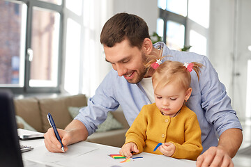 Image showing working father with baby daughter at home office