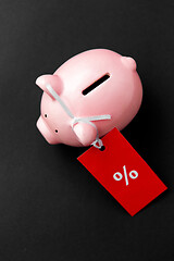 Image showing piggy bank with red sale tag on black