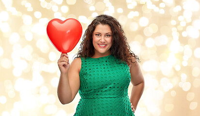 Image showing happy woman holding red heart shaped balloon