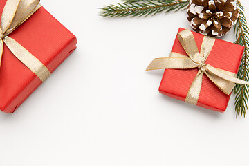 Image showing christmas gifts and fir branches with pine cones