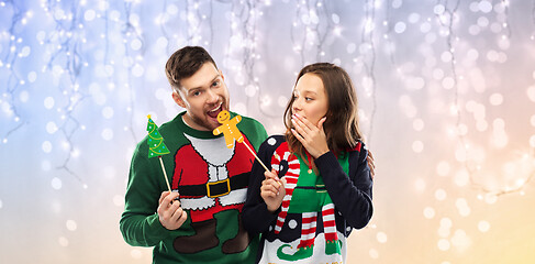 Image showing couple with christmas party props in ugly sweaters