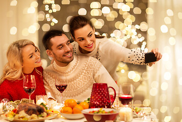 Image showing friends taking selfie at christmas dinner