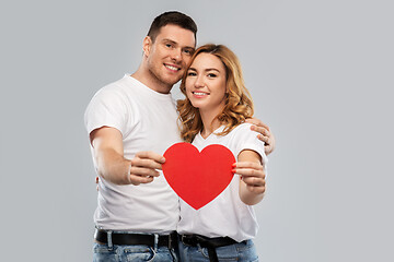 Image showing smiling couple holding big red heart