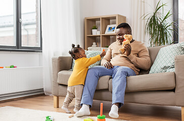 Image showing african american father playing with baby at home