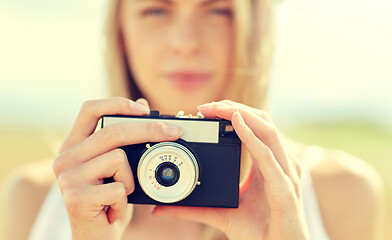 Image showing close up of woman photographing with film camera