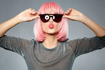 Image showing woman in pink wig and sunglasses sending air kiss