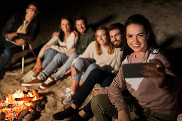 Image showing happy friends taking selfie at camp fire on beach