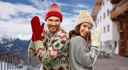 Image showing happy couple in ugly christmas sweaters in winter