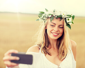 Image showing happy young woman taking selfie by smartphone