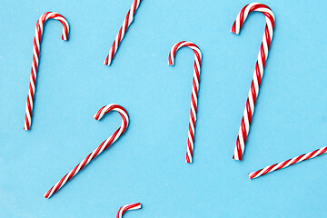 Image showing candy cane decorations on blue background