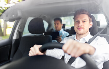 Image showing male driver driving car with passenger