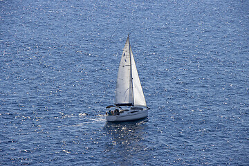 Image showing Sailingboat with white sails at opened sea