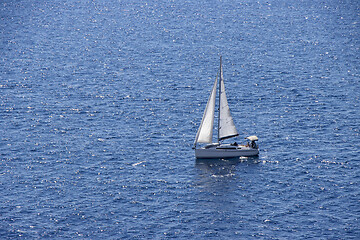 Image showing Sailingboat with white sails at opened sea