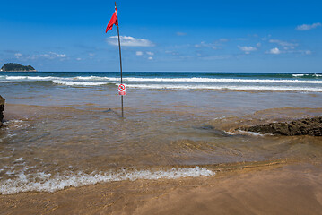 Image showing Red flag on the beach. Swimming and surfing ban.
