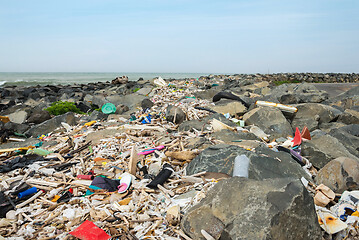 Image showing Spilled garbage on the beach near the big city. Empty used dirty plastic bottles and other garbage. Environmental pollution. Ecological problem.