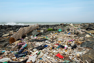 Image showing Spilled garbage on the beach near the big city. Empty used dirty plastic bottles and other garbage. Environmental pollution. Ecological problem.