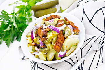 Image showing Salad potato with bacon and cucumber in plate on towel