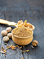 Image showing Nutmeg round in bowl and spoon with mace on board