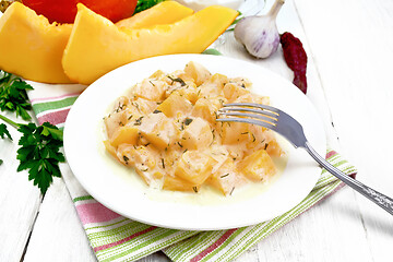 Image showing Pumpkin with sour cream sauce in plate on white wooden board