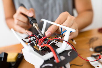 Image showing Man welding on the borad of drone