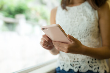 Image showing Woman sending sms on mobile phone