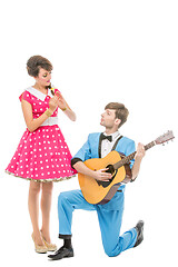 Image showing doll looking boy and girl with guitar