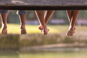 Image showing people sitting at wooden bridge