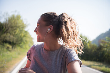 Image showing woman jogging along a country road