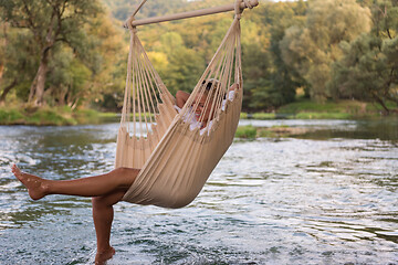 Image showing blonde woman resting on hammock