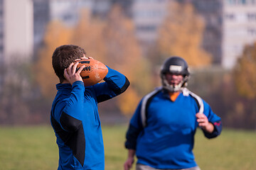 Image showing american football team with coach in action