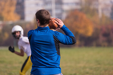 Image showing american football team with coach in action