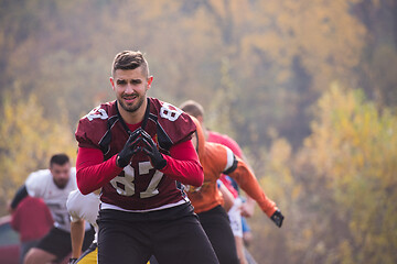 Image showing american football players stretching and warming up