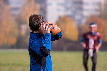 Image showing american football team with coach in action