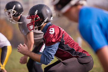 Image showing american football players stretching and warming up