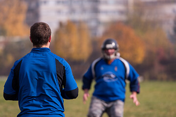 Image showing american football team with coach in action