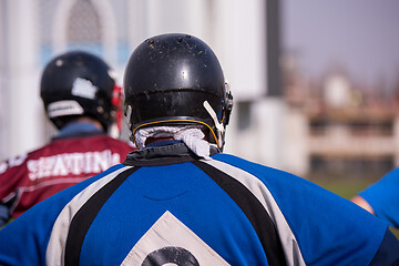 Image showing american football team with coach in action