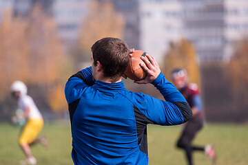 Image showing american football team with coach in action