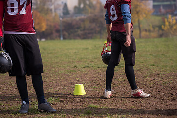 Image showing American football player holding helmet