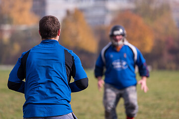 Image showing american football team with coach in action