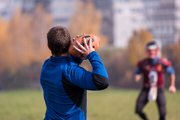 Image showing american football team with coach in action