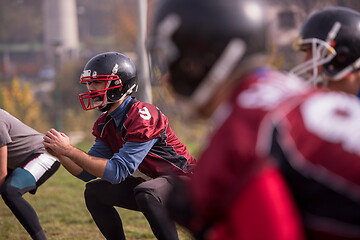 Image showing american football players stretching and warming up