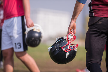 Image showing American football player holding helmet