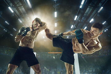 Image showing Two professional boxers boxing on the ring