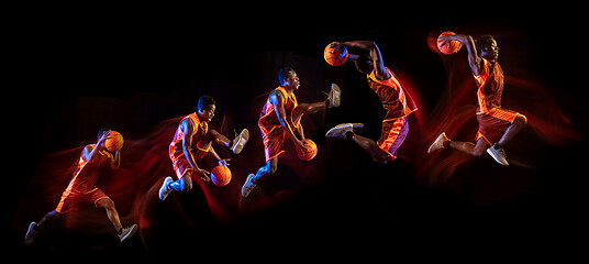 Image showing Young basketball player against dark background