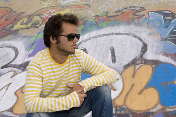 Image showing men next to a graffiti wall